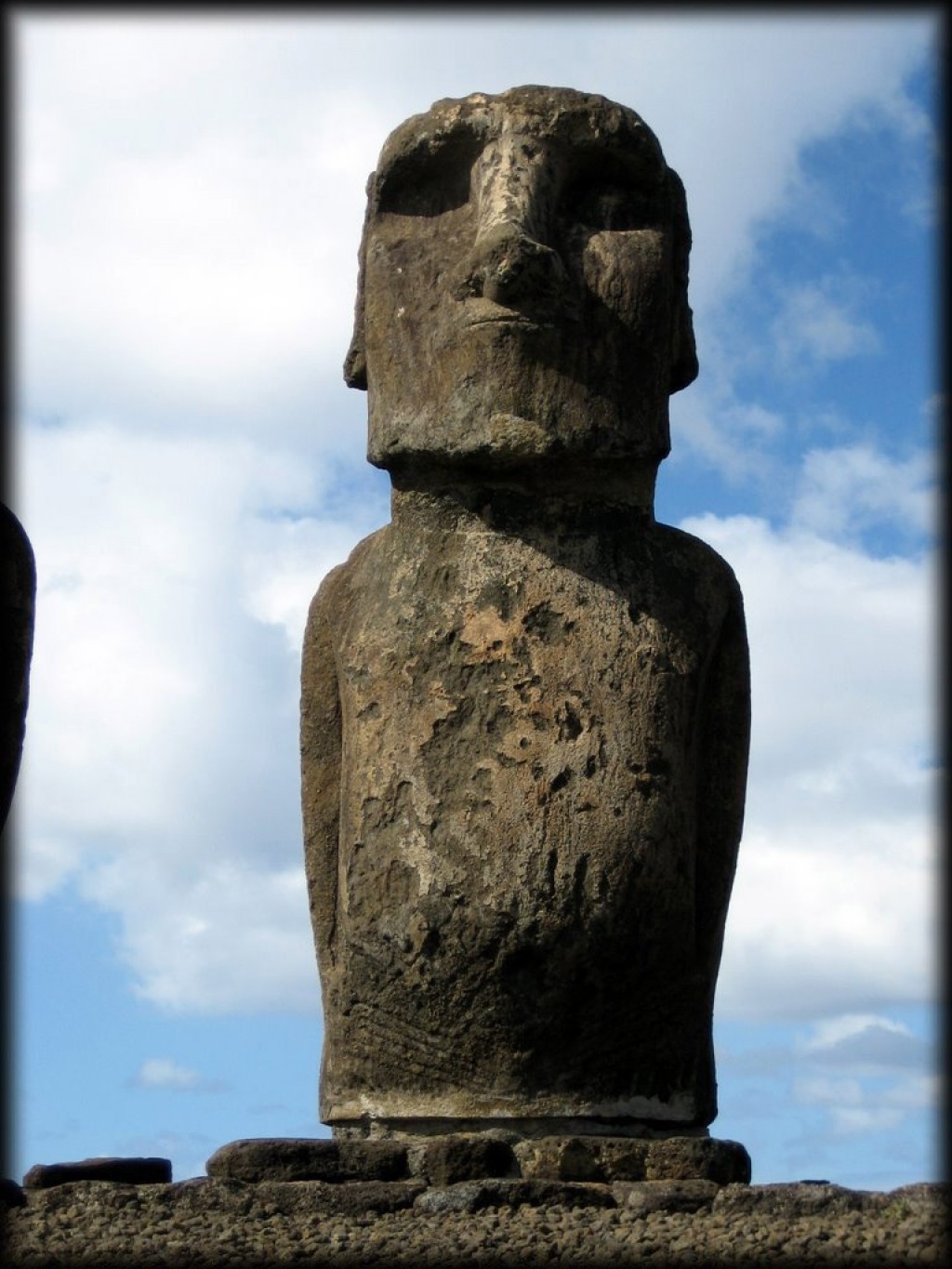 The Moai at Ahu Tongariki were  reconstructed by a large team of scientists and local experts (1992/5). A Japanese company financed part of the work.

The monument, in ruins before the arrival of Europeans explorers of the 18 century (15 statues down and broken), was completely destroyed by a tsunami originated in Chile (22 May, 1960) as the main consequence of the most important earthquake ever recorded in human history (9.5) not by a cyclone that would not have any effect on a megalithic structure.
