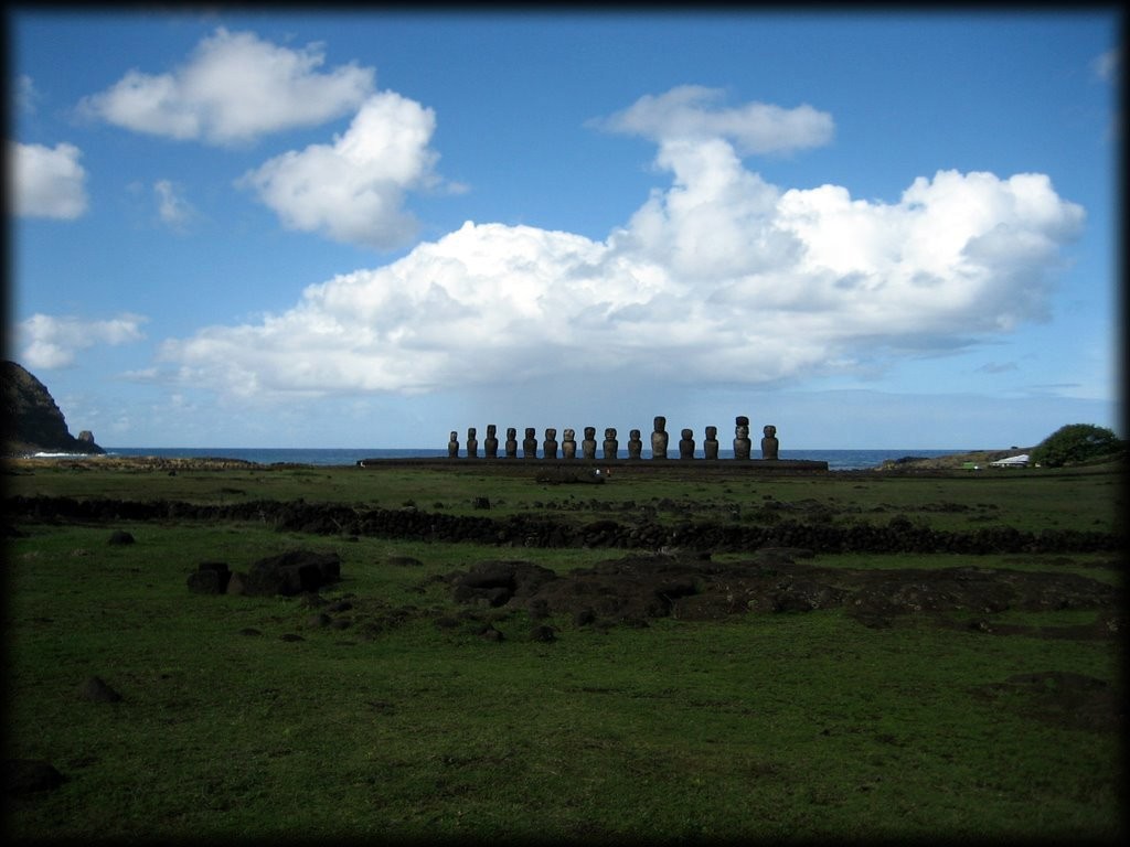 The Moai at Ahu Tongariki were  reconstructed by a large team of scientists and local experts (1992/5). A Japanese company financed part of the work.

The monument, in ruins before the arrival of Europeans explorers of the 18 century (15 statues down and broken), was completely destroyed by a tsunami originated in Chile (22 May, 1960) as the main consequence of the most important earthquake ever recorded in human history (9.5) not by a cyclone that would not have any effect on a megalithic structure.

