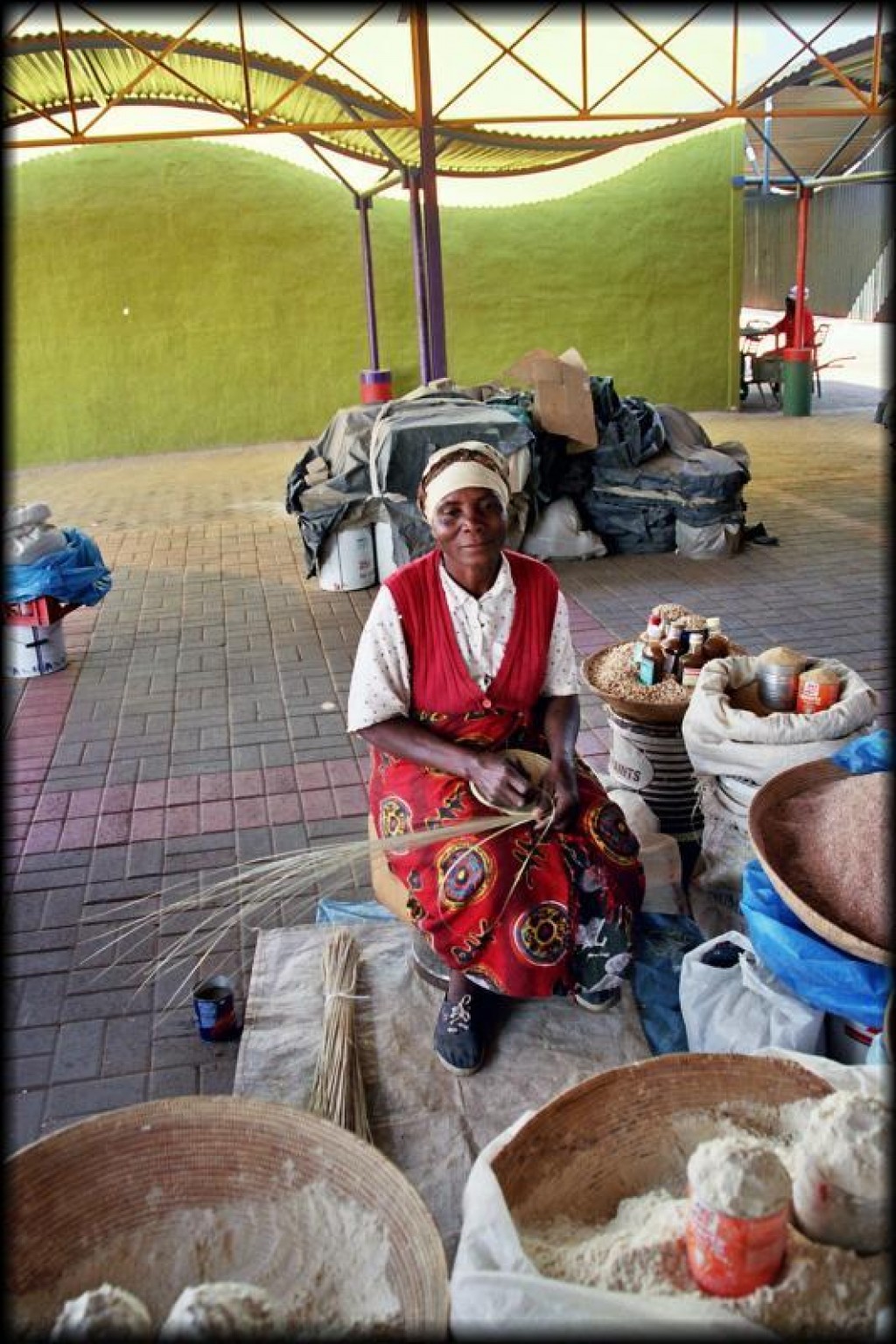 This lady was making baskets to hold the flour.