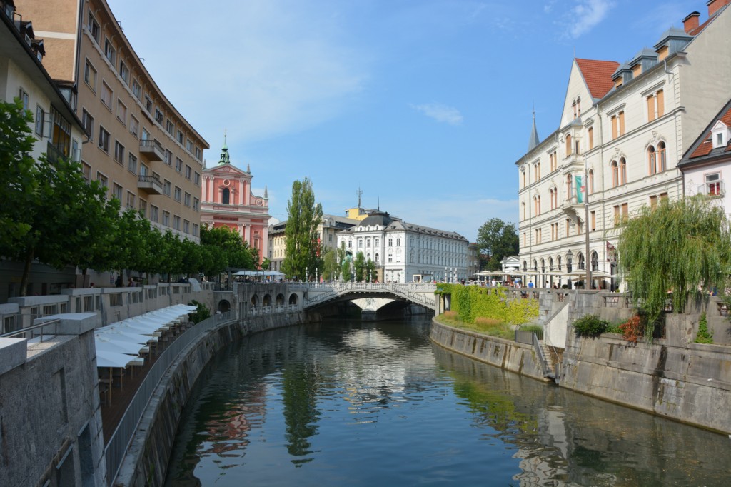 Ljubljanica river running through downtown with restaurants and shops on either side.  Beautiful!