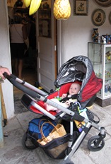 Facing backward in the seat of the UPPAbaby Vista.  Notice all the stuff we've managed to shove into the basket!