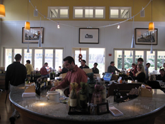 The bar in the Duckhorn Vineyards Estate Winery tasting room is ringed with tables and flooded with natural light from its many windows.  The views out over the winery are beautiful.  Unfortunately they don't make up for the quality of the wine.