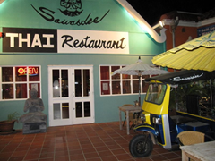 A tuk tuk on the front patio welcomes you to Sawasdee Thai Restaurant, a couple of blocks from the highrise strip in Aruba.