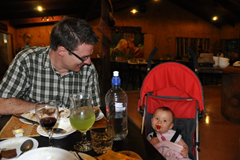 Relaxing after dinner in her UppaBaby GLite which is doing its usual double duty as a travel highchair.
