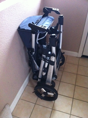 The UPPAbaby Vista stroller folds with the Graco car seat attachment on.  The stroller stands on its own and the RumbleSeat stores neatly between it and the wall when flipped upside down.  All in all it takes up remakably little room in our foyer for a double stroller.  Those are 6" tiles, just for reference.