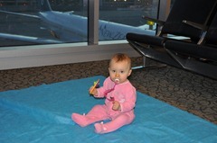 Crawling in the airport.  The drop cloth was our vain attempt to keep her clean.  By the way home, we'd given up!  (Just plan on trashing those pants - they're never coming clean!)