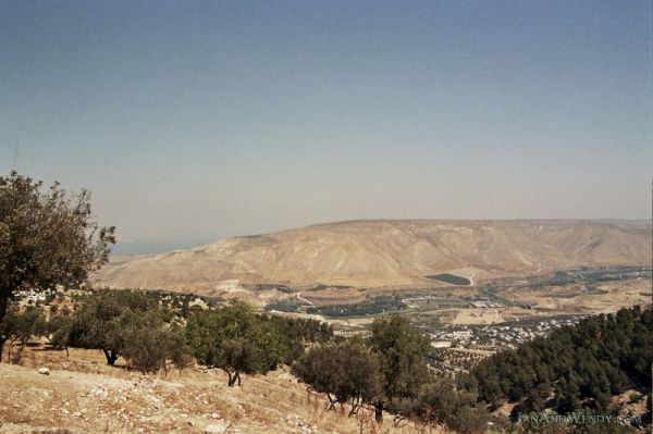 The view from Um Qais, Jordan to Syria, with the hills dotted with olive trees.